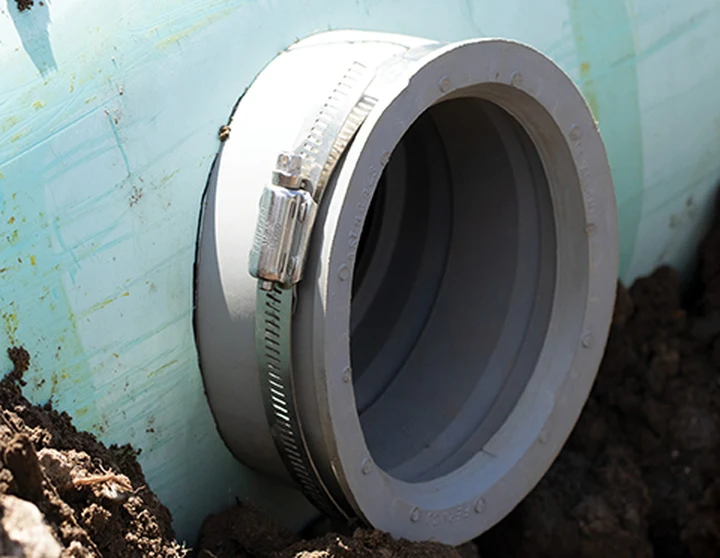Fernco QwikSeal gasket clamped into a cored opening in a PVC sewer main