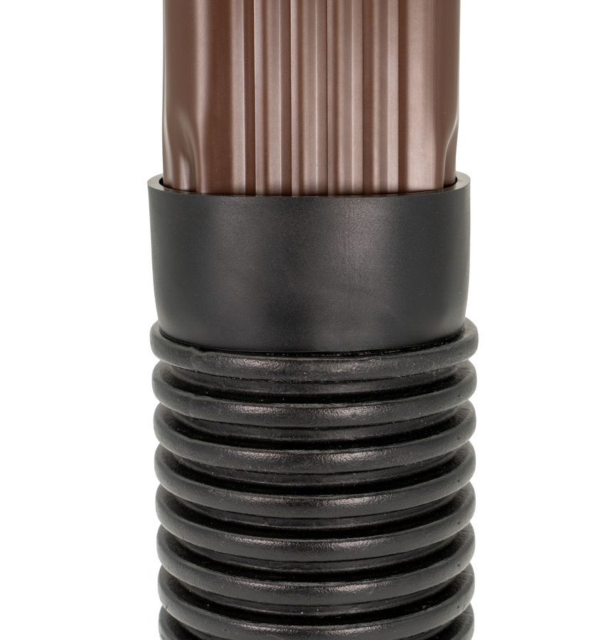 A brown downspout pushed into a DSC-33 connector on black corrugated drain pipe
