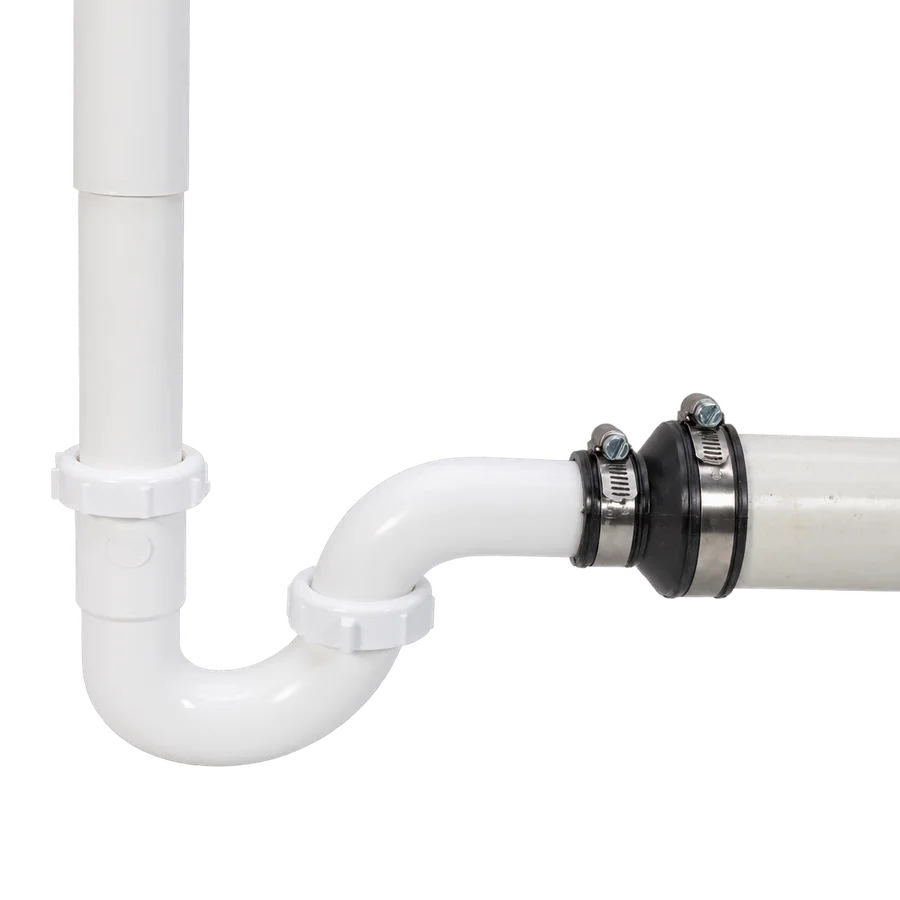Fernco Drain & Trap Connector joining a white plastic tubular trap arm to larger drain pipe