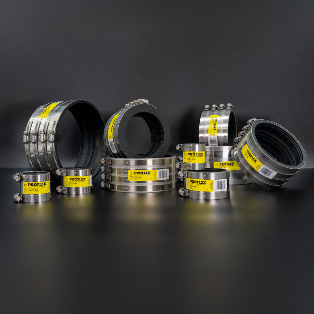 A group of Fernco Proflex shielded couplings in several sizes on a dark background