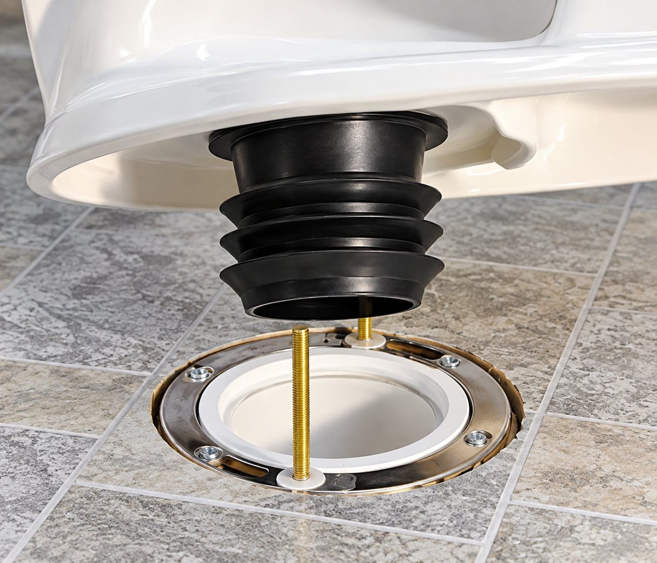 Toilet with a Fernco wax-free toilet seal being lowered onto a floor flange